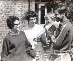 an old black and white photo of people talking to each other