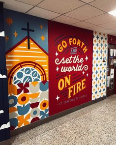 the mural is painted on the side of the building and it says go forth and see the world on fire