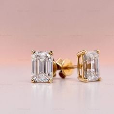 pair of diamond earrings on pink background