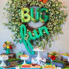 a table topped with lots of food and balloons