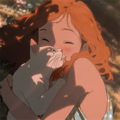 a woman with red hair is holding a cat and kissing her face in the sun