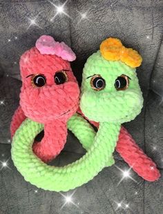 two knitted toys sitting next to each other