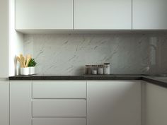 a kitchen with white cabinets and black counter tops is seen in this image from the front view