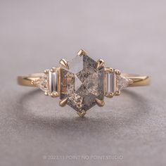 an engagement ring with three stone accents on the sides and two diamonds in the middle