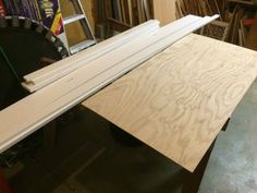 a table that has some wood on it and is being worked on by a person