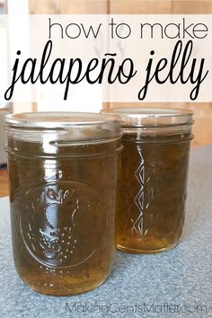 two jars filled with jalapeno jelly sitting on top of a countertop