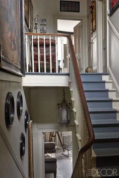 the stairs lead up to the second floor and another room with pictures on the wall