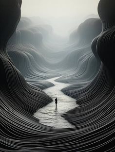 a man standing in the middle of a river surrounded by hills and mountains with water flowing between them