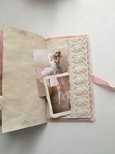 an open book with pictures and lace on it