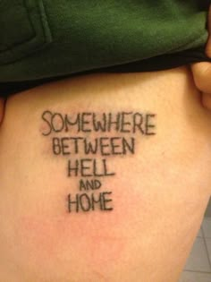 someone with a tattoo saying somewhere between hell and home