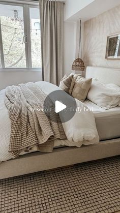 a bed sitting in a bedroom next to a window with curtains on the windowsill