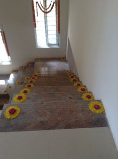 the stairs are decorated with yellow and red flower garlands, along with other decorations