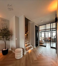 a living room filled with furniture and a tree in the middle of it's floor