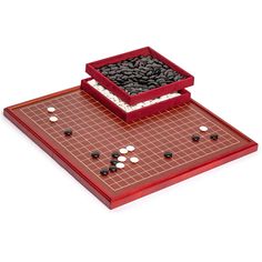 a board game with dices on it and a red tray that has two black squares in the middle