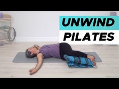 a woman laying on top of a yoga mat with the words unwind pilates