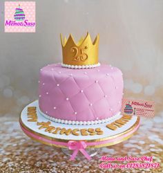 a pink cake with a gold crown on top