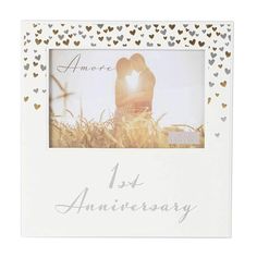 an anniversary photo frame with hearts on it