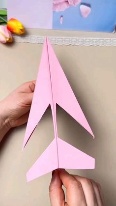 someone is making a paper airplane that looks like a plane