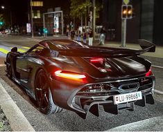 a black sports car is parked on the street