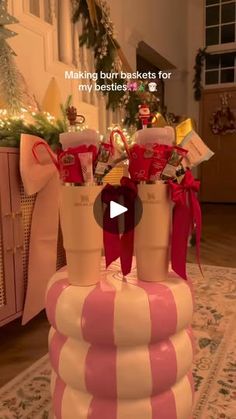 a large pink and white striped basket filled with candy canes on top of a rug