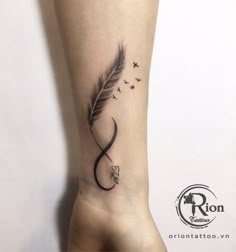 a small feather tattoo on the ankle with an infinite sign and birds flying around it