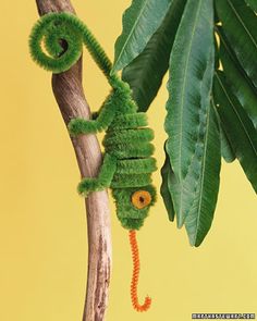 a very cute looking caterpillar on a tree branch with polka dots around it