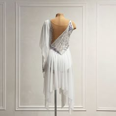 a dress on display in front of a white wall