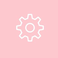 a white gear wheel on a pink background