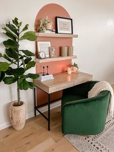 a green chair sitting in front of a desk with a potted plant next to it