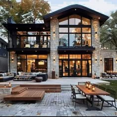 a large house with lots of windows and patio furniture