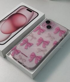 an iphone case with pink bows on it in a white box next to the packaging