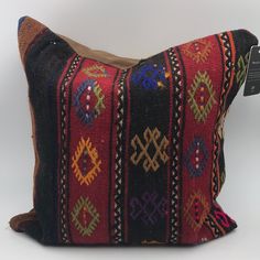 a decorative pillow made from an old kilim cloth with geometrical designs on it