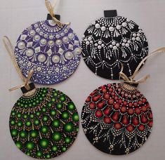 three hand painted ornaments are hanging on a table