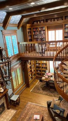 the inside of a house with stairs and bookshelves