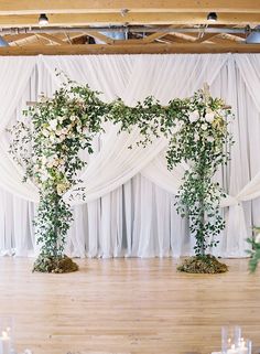 an arrangement of flowers and greenery on the dance floor