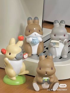 four little toy animals sitting on top of a table