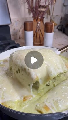 an omelet is being cooked in a pan with a spatula on the stove