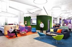 an office filled with colorful furniture and people