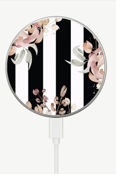 a black and white striped phone charger with pink flowers on the side, attached to a usb cable