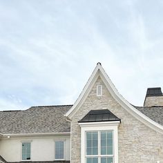 a large house with a clock on the side of it's face and windows