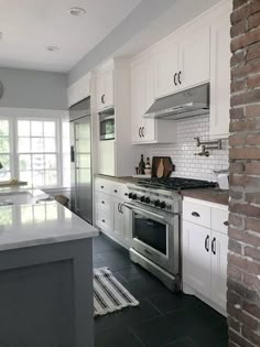 a kitchen with white cabinets and an oven