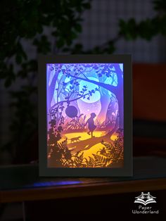 a card with an image of a person in the woods at night, on top of a table