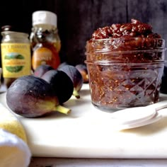 figs and honey sit on a cutting board