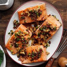 salmon with nuts and green onions on a plate