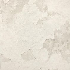 a white wall with peeling paint on it