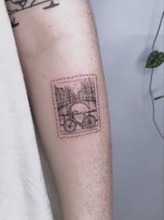 a man's arm with a stamp on it that has an image of a bicycle