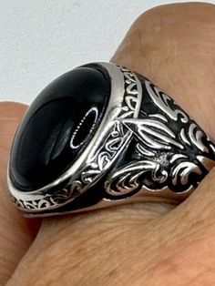 This is a Persian-styled vintage onyx mens ring set in 925 sterling silver accented with 14k gold and a genuine black onyx. This is a gorgeous ring, intricate detail work on the silver set with a beautiful onyx. We have in a sizes 9, 10 11 or 12 this can be sized to your specification, please message us to discuss sizing your ring there is a $20 fee. or engraving options. All of our jewelry is hand polished and shipped to you in a stylish gift box.  We are happy to gift wrap for you.  It is impo Timeless Black Signet Ring With Gemstone, Black Cabochon Signet Ring For Formal Occasions, Formal Black Cabochon Signet Ring, Classic Black Engraved Ring With Black Enamel, Formal Black Engraved Ring With Polished Finish, Black Engraved Ring With Polished Finish For Formal Occasions, Classic Black Onyx Signet Ring, Classic Black Sterling Silver Engraved Ring, Classic Black Cabochon Rings