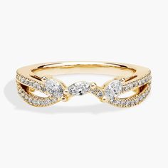 a yellow gold ring with three diamonds on it