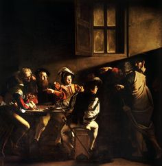 a group of people sitting at a table in a room with one person holding a knife