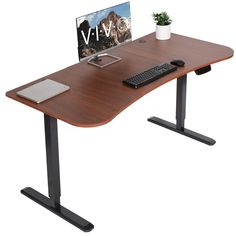 two computer monitors sitting on top of a wooden desk next to a keyboard and mouse